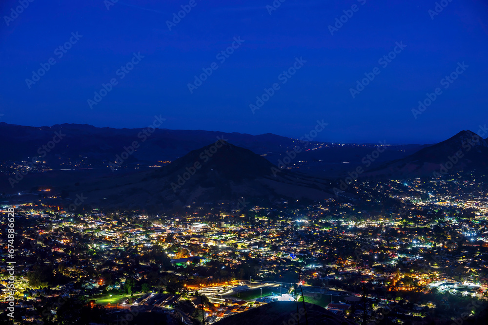 View of valley, mountains at night with lights