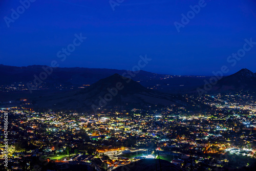 View of valley, mountains at night with lights