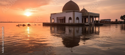 Masjid Wall Adhuna, Muara baru, Jakarta Utara, Indonesia - July 21, 2021 : Mosque submerged in water due to tidal flooding. blur and noise