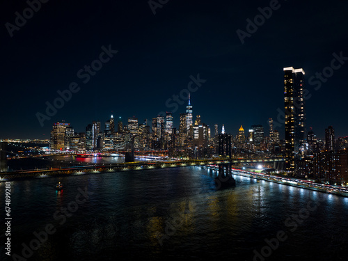 Night aerials New York City. View of river and bridges lit