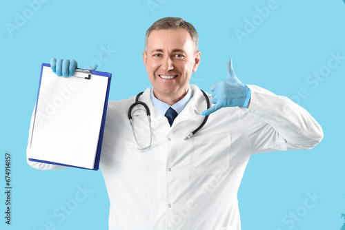 Mature doctor with clipboar...