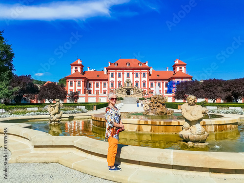 Obraz na plátně Senior woman on excursion in Troja Palace is a Baroque palace located in Troja,