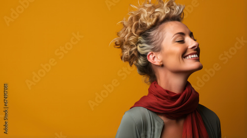 Image of excited screaming young woman standing isolated over yellow background. Looking up.