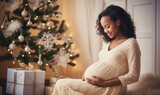 pregnant woman in dress touching her belly on the background of Christmas tree
