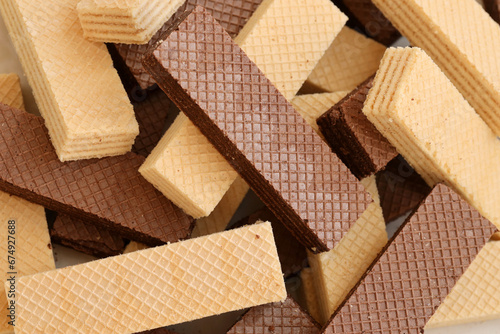 Stacked delicious chocolate wafers in large amount. Two different flavours of classic small waffles photo