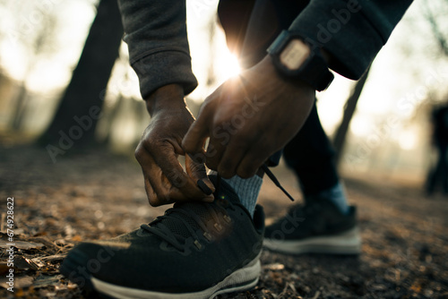 Athlete Tying Running Shoes for Morning Training Outdoors