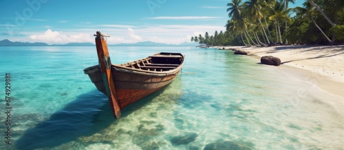 In the vintage beach town with a backdrop of lush nature a picturesque wooden boat gently floats on the sparkling turquoise ocean embracing the tranquil beauty of an old island getaway © TheWaterMeloonProjec