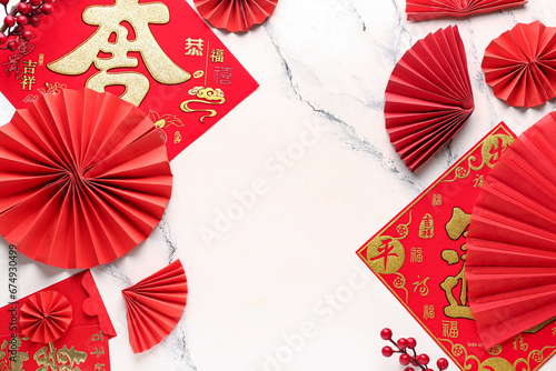 Traditional napkins with red envelopes, fans and Chinese symbols on grunge white background. New Year celebration