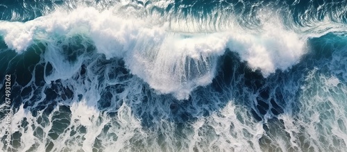 Beautiful texture of big power dark ocean waves with white wash. Aerial top view footage of fabulous sea tide on a stormy day. Drone filming breaking surf with foam in Indian ocean. Big swell in Bali.