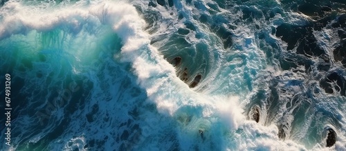 Beautiful texture of big power dark ocean waves with white wash. Aerial top view footage of fabulous sea tide on a stormy day. Drone filming breaking surf with foam in Indian ocean. Big swell in Bali.