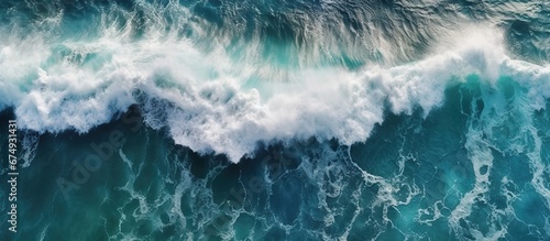 Beautiful texture of big power dark ocean waves with white wash. Aerial top view footage of fabulous sea tide on a stormy day. Drone filming breaking surf with foam in Indian ocean. Big swell in Bali. © haizah
