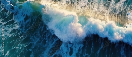 Beautiful texture of big power dark ocean waves with white wash. Aerial top view footage of fabulous sea tide on a stormy day. Drone filming breaking surf with foam in Indian ocean. Big swell in Bali. photo