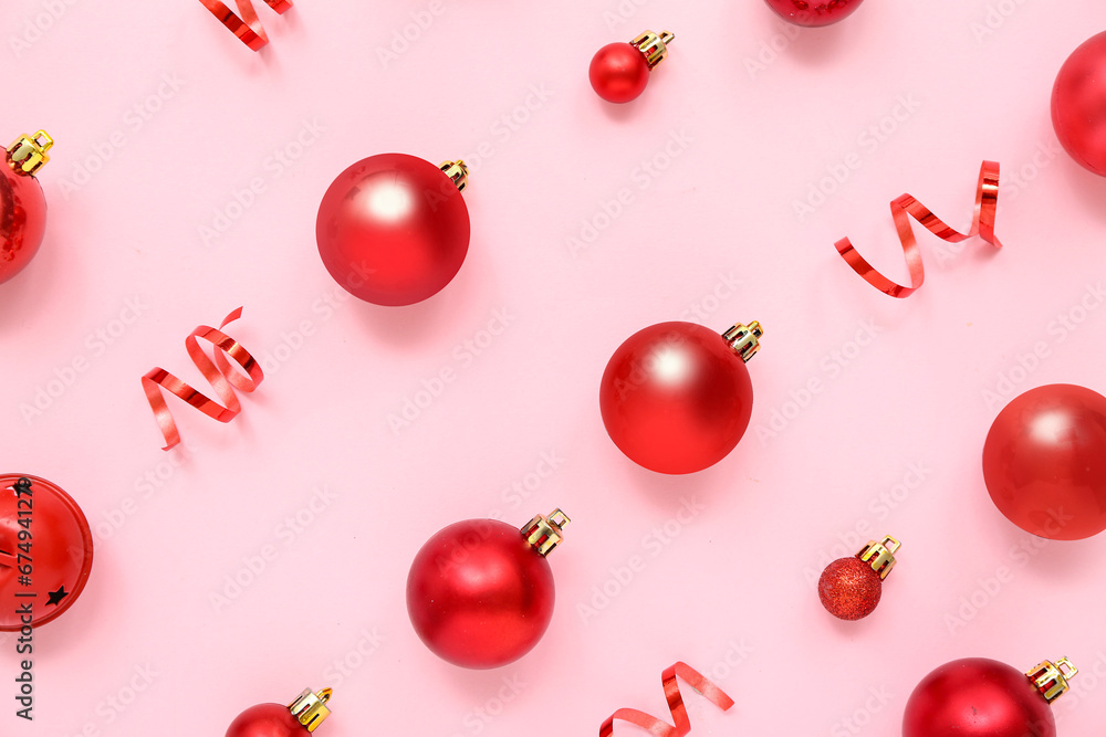 Composition with red Christmas balls and ribbons on pink background Composition with red Christmas balls and ribbons on pink background