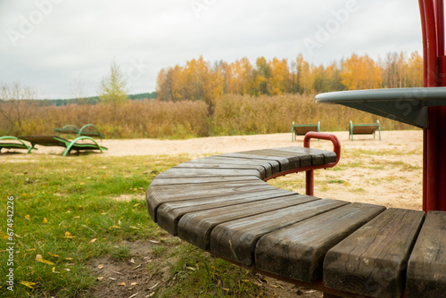 A bench on a lake shore at the lake beach photo