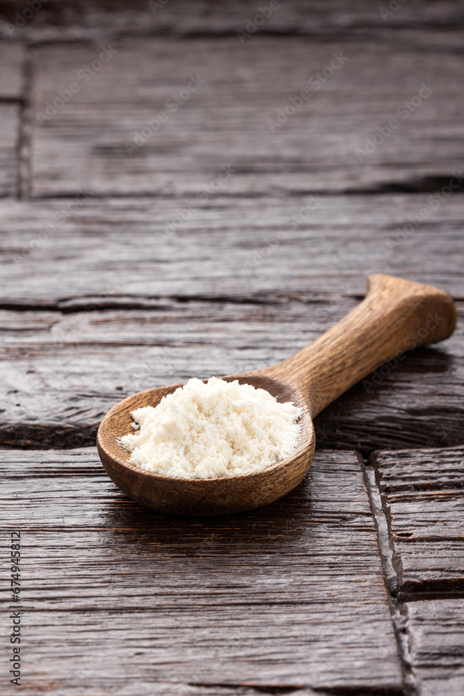Hydrolyzed collagen protein in spoon - Rustic wooden background Hydrolyzed collagen protein in spoon - Rustic wooden background