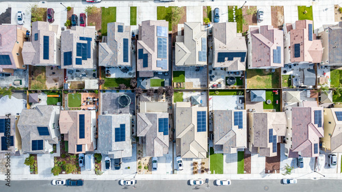 Top down view of a row of residential homes with solar panels on the roof