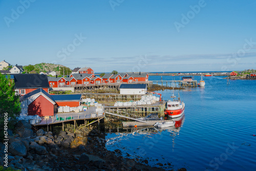 Summer in Reine, Lofoten Islands, Norway. Popular tourist destination. Old fishermans village with wooden red cottages Rorbuer - by Classic Norway Hotels © Ilja