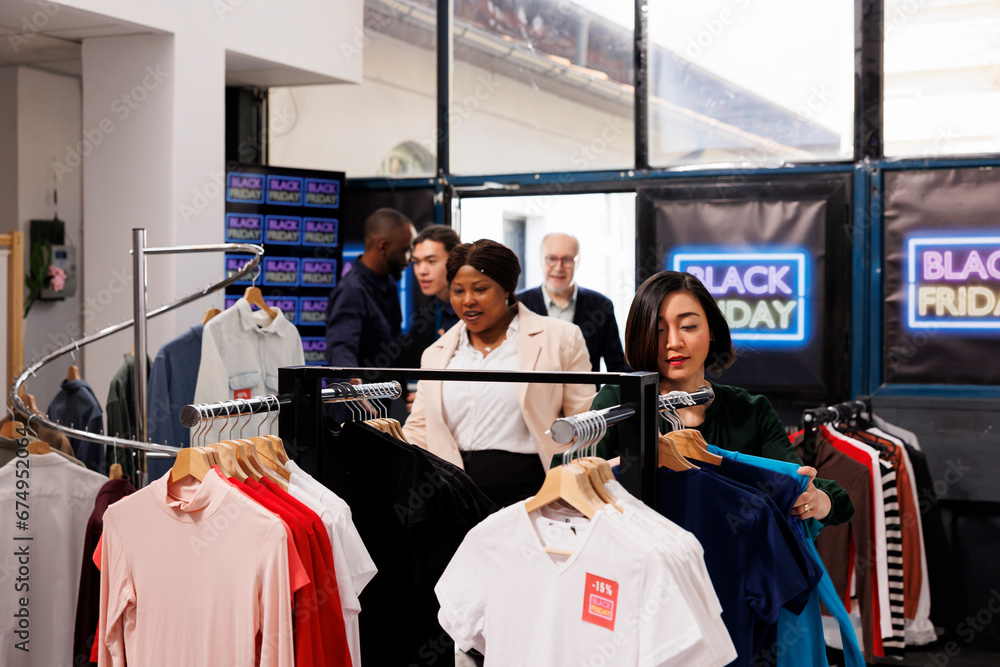 Shopping season. Security guard opening clothing store on Black Friday, letting customers in. Excited overjoyed diverse people shoppers doing impulse purchases, buying clothes at discount prices Shopping season. Security guard opening clothing store on Black Friday, letting customers in. Excited overjoyed diverse people shoppers doing impulse purchases, buying clothes at discount prices