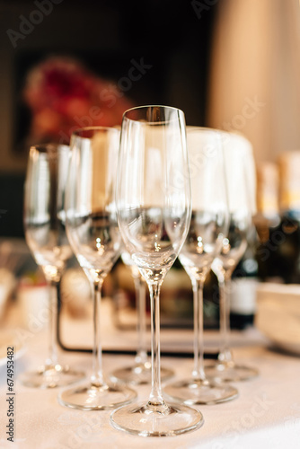 Champagne glasses standing on a table, festive atmosphere, luxurious decor event