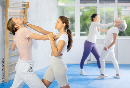 Active women are training captures on the self-defense course in gym