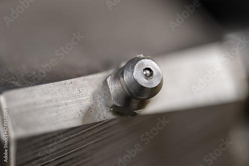 Macro detail of metal grease nipple. photo