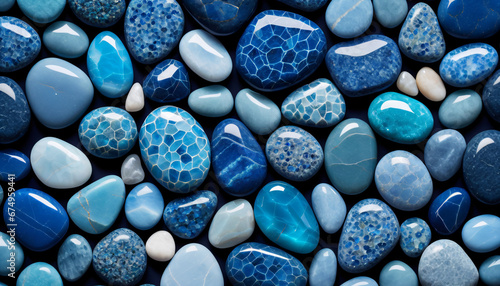 Assorted blue polished gemstones collection, showcasing various shapes and shades in a close-up view