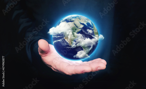 Man hold in hand Earth planet with clouds. Concept of saving the world  protecting the environment. Communication relationships.