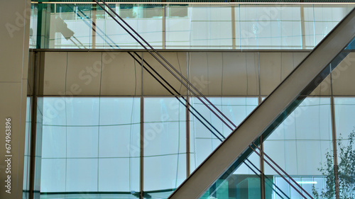 Steel and glass. The subject of modern architecture or construction industry. Modern office building facade with tall steel construction elements and full height windows between. 