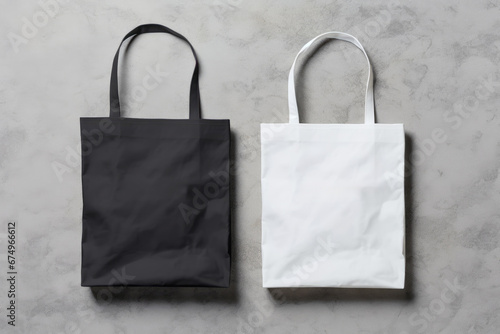 White and black tote bags mockup on a grey background