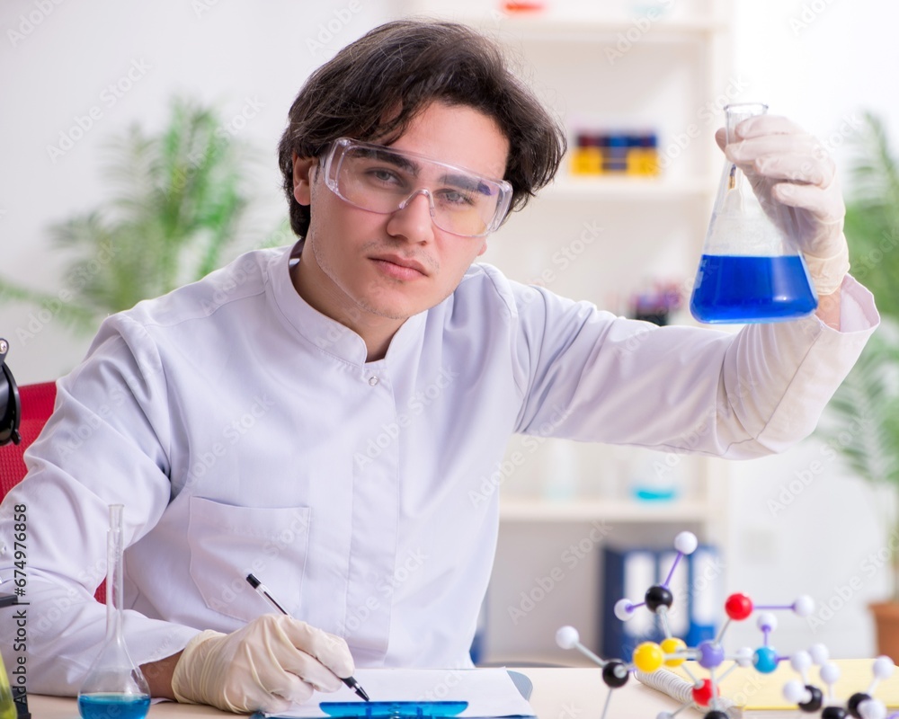 Young male biochemist working in the lab Young male biochemist working in the lab