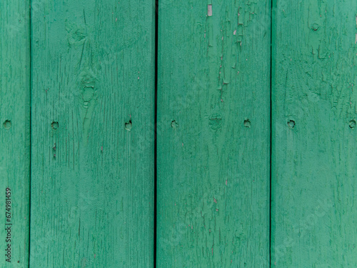 The texture of wooden fence boards. Green color