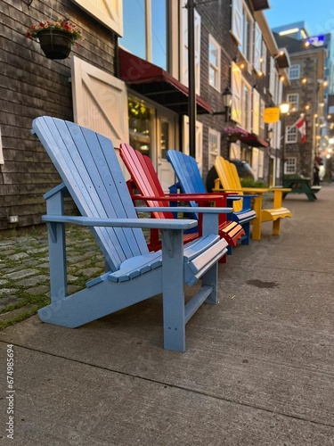 Row of colorful outdoor chairs along a sidewalk