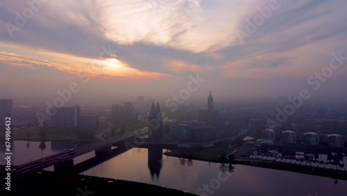 Drone shot of Roermond cityscape at sunrise with St. Cristopher's Cathedral and Munsterkerk photo