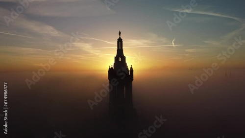 Drone footage of the St. Christopher Cathedral bell tower on a foggy morning, Roermond, Netherlands photo
