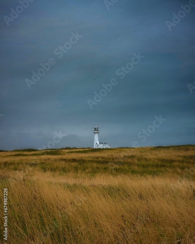 Lighthouse is located atop a grassy hill in Flamborough  Bridlington  United Kingdom