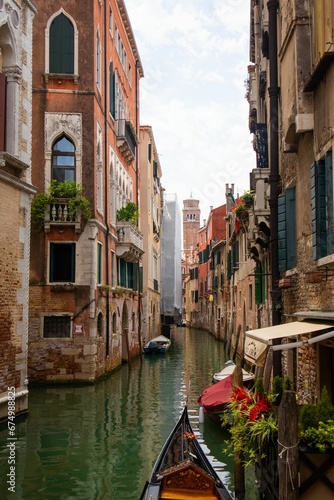 a small boat is in a quiet alleyway lined with buildings