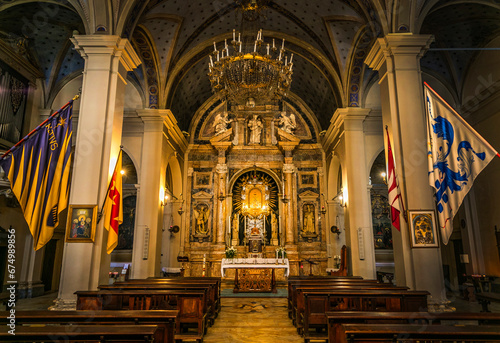 Grand church interior  featuring a seating area with rows of chairs  and ornate wall decorations