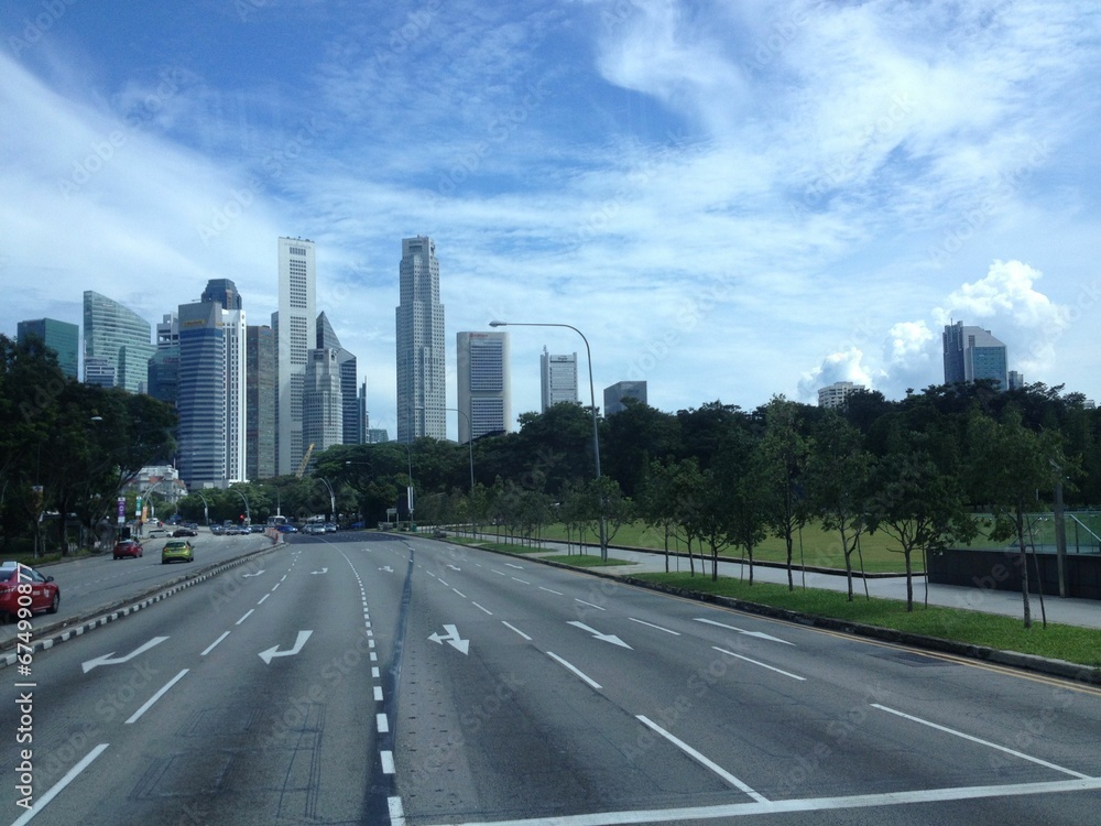 Bustling metropolitan cityscape with tall skyscrapers and busy roads filled with cars