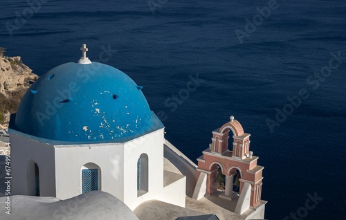 Beautiful blue domed church over the water in Santorini, Greece