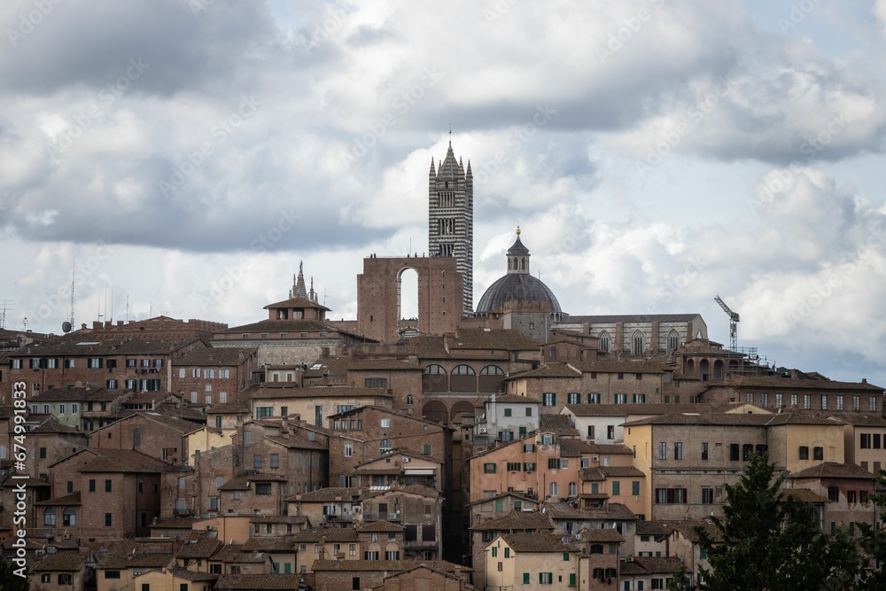 Beautiful shot of historic buildings under a dramatic sky in Siena, Italy