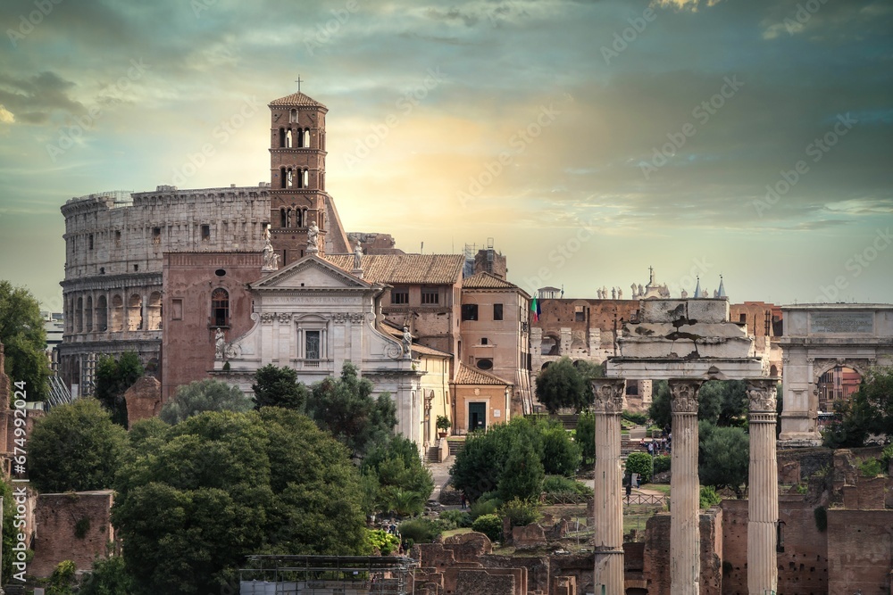 A beautiful shot of historic buildings including the Colosseum at sunset in Rome, Italy