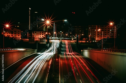 Long-exposure of illuminated freeway surrounded by skyscrapers at night