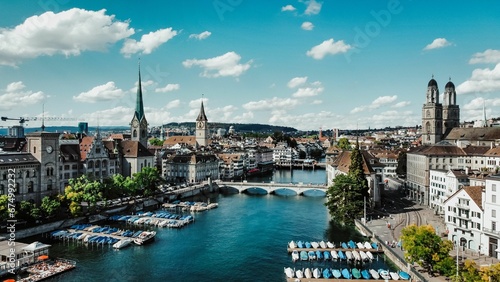 Scenic view of a riverbank with multiple sailboats and motorboats in the waters in Zurich photo