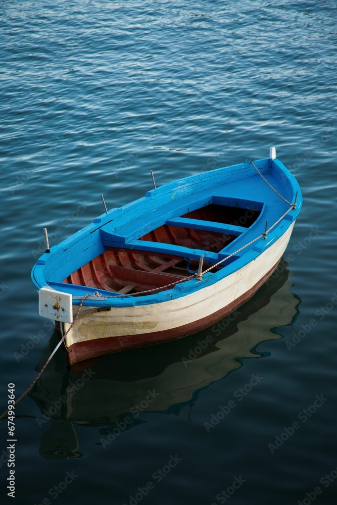 Vertical of a wooden boat in a tranquil lake
