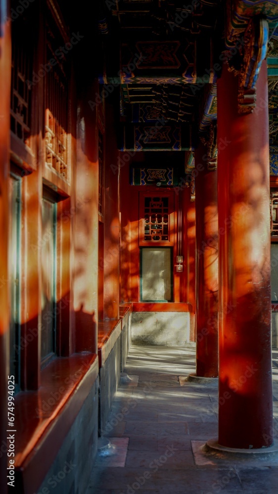 Row of windows in an Asian-style building emit a warm golden light, creating an inviting atmosphere