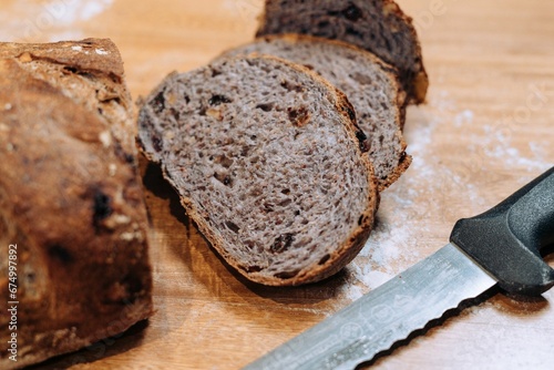 Close-up shot of a freshly sliced loaf of bread on a cutting board photo