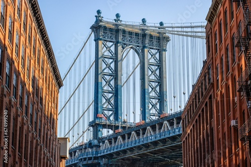 Fototapeta Naklejka Na Ścianę i Meble -  Manhattan Bridge between buildings in the Dumbo neighborhood in Brooklyn, NYC