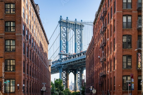 Manhattan Bridge between buildings in the Dumbo neighborhood in Brooklyn, NYC photo