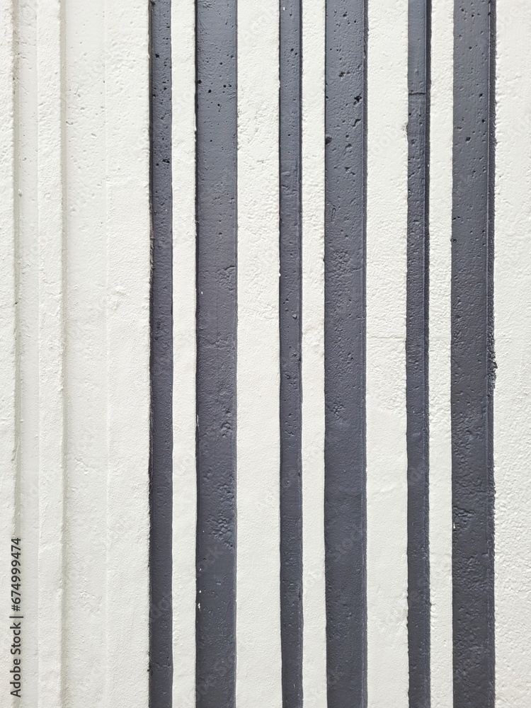 Painted black and white vertical stripes on concrete wall, bar code pattern texture Painted black and white vertical stripes on concrete wall, bar code pattern texture