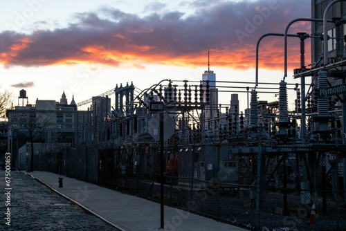 Electric power station in the foreground  with Manhattan Bridge at sunset.